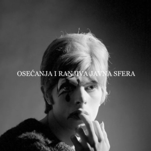 Young David Bowie in 1967 posing in a white cashmere sweater, photographed by Gerald Fearnley